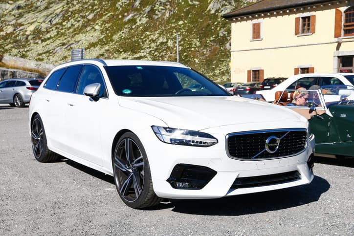 White luxury estate car - Volvo V90 in the countryside